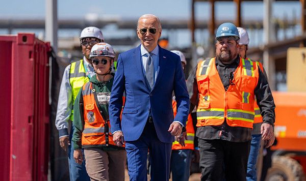 Joe Biden and union members building Intel's Ocotillo Campus walk onstage before announcing $20 billion in investments to ramp up production of semiconductor chips under the CHIPS & Science Act, Wednesday, March 20, 2024, in Chandler, Arizona. (Official White House photo by Adam Schultz)