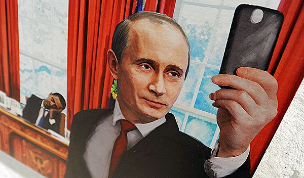 Vladimir Putin depicted in artwork taking a selfie with Barack Obama dozing in the background inside the Oval Office.